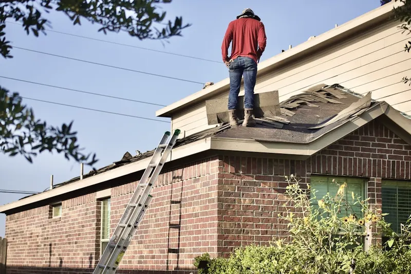Professional roofer working on a residential roof in Humarock
